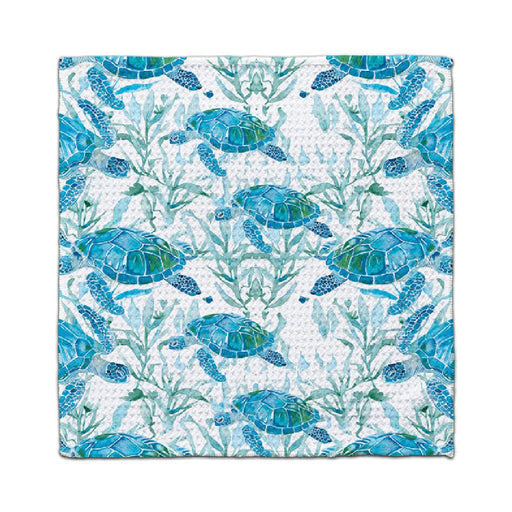 A blue and white towel featuring a pattern of sea turtles swimming across the fabric.