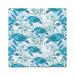 A blue and white towel featuring a pattern of sea turtles swimming across the fabric.