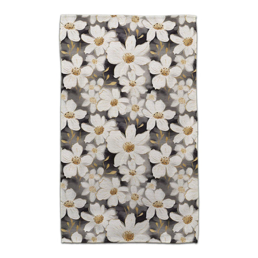 A white and gold floral pattern elegantly contrasts against a black background.