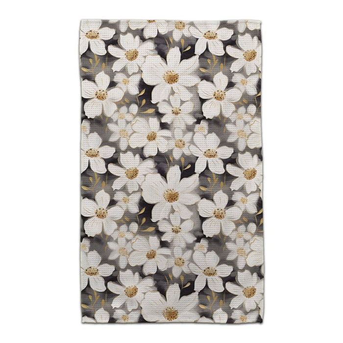 A white and gold floral pattern elegantly contrasts against a black background.