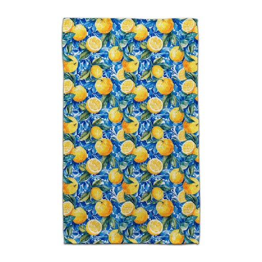 A towel featuring a pattern of lemons and green leaves on a light background.