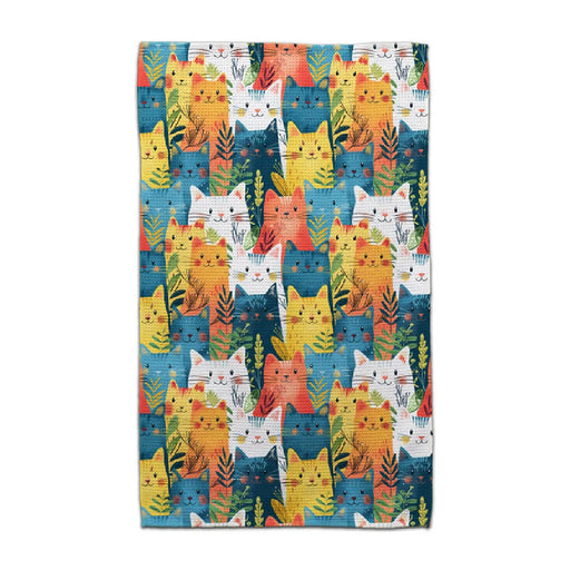 A blue towel adorned with a playful, colorful cat design.