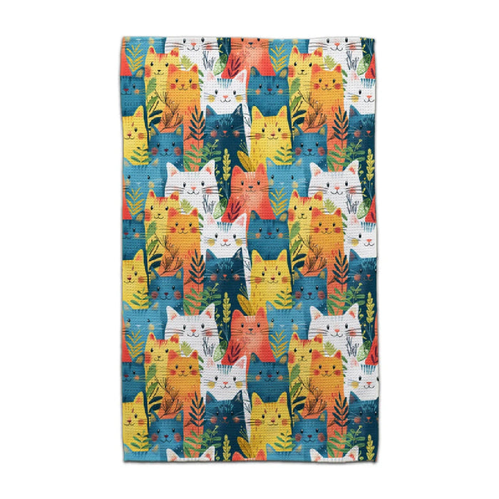 A blue towel adorned with a playful, colorful cat design.