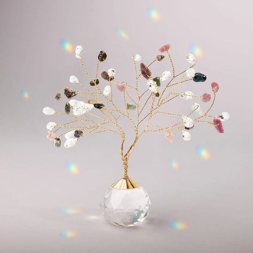 Suncatcher Tree of Life with tourmaline crystals hanging in sunlight casting rainbow reflections