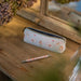 A pencil case showcasing a decorative flower motif.