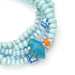 Scout Curated Wears Joy/Bluebird wrap bracelet/necklace with pale blue ceramic beads, patterned beads, and bluebird charm.