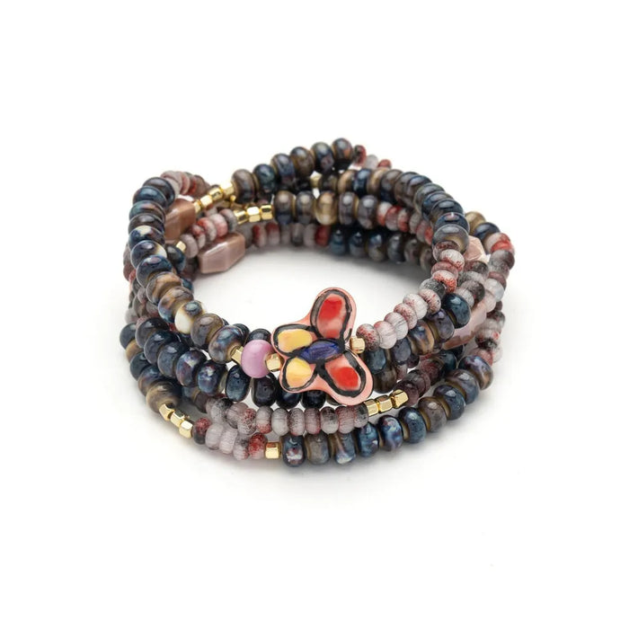 Scout Curated Wears ceramic bead wrap bracelet/necklace with multicolored beads and butterfly charm on Transformation card.