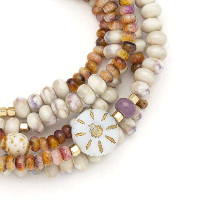 Scout Abundance/Sun ceramic bead wrap bracelet/necklace with cream, pink, amber, and lavender beads and a gold-tone sun motif.