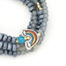 Scout Curated Wears Hope/Rainbow ceramic bead wrap bracelet and necklace with gray beads, gold-tone accents, and a colorful rainbow charm.