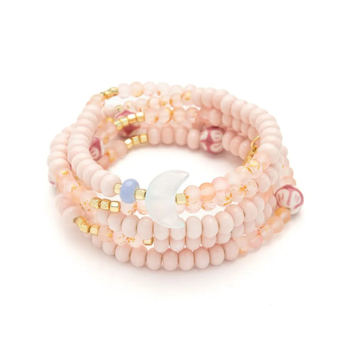 Scout Curated Wears pink beaded Balance/Moon bracelet and necklace on a display card reading “Moon, symbol of balance.