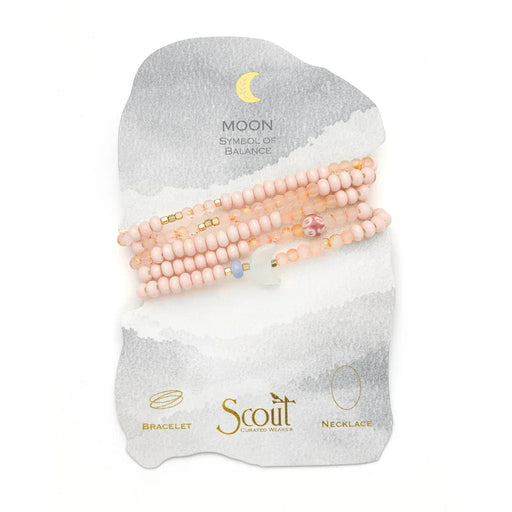 Scout Curated Wears pink beaded Balance/Moon bracelet and necklace on a display card reading “Moon, symbol of balance.