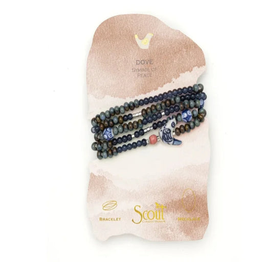 Scout Curated Wears Peace/Dove ceramic bead wrap bracelet/necklace with dark navy, muted green, and bronze-toned round beads, silver-toned spacers, blue-and-white patterned ceramic accents, and a white dove-shaped charm with blue detailing.
