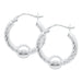 Silver hoop earrings with spherical ends on a white background