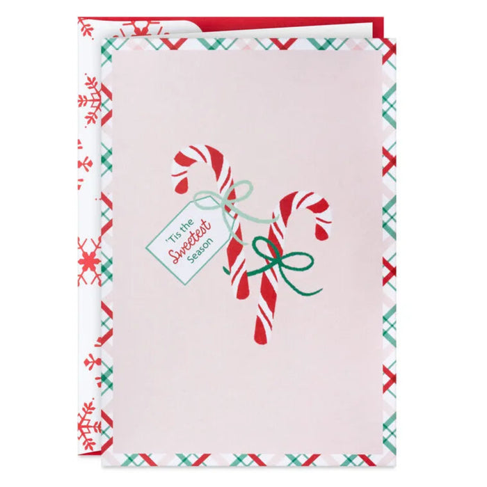Christmas card with candy canes and a tag on a white background