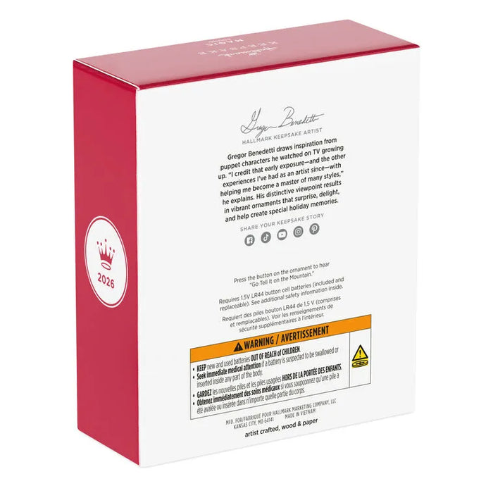 Side angle of Hallmark ornament packaging displaying 2026 crown emblem and bilingual hazard labels