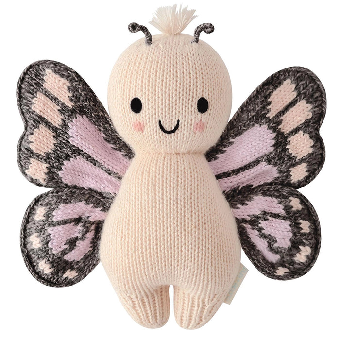 Cuddle + Kind Baby Butterfly in Peach – front view of handmade knit stuffed butterfly doll with smile and patterned wings.