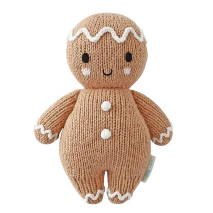 Cuddle + Kind Baby Gingerbread Doll – White Icing Edition, handmade knit holiday plush with embroidered details.