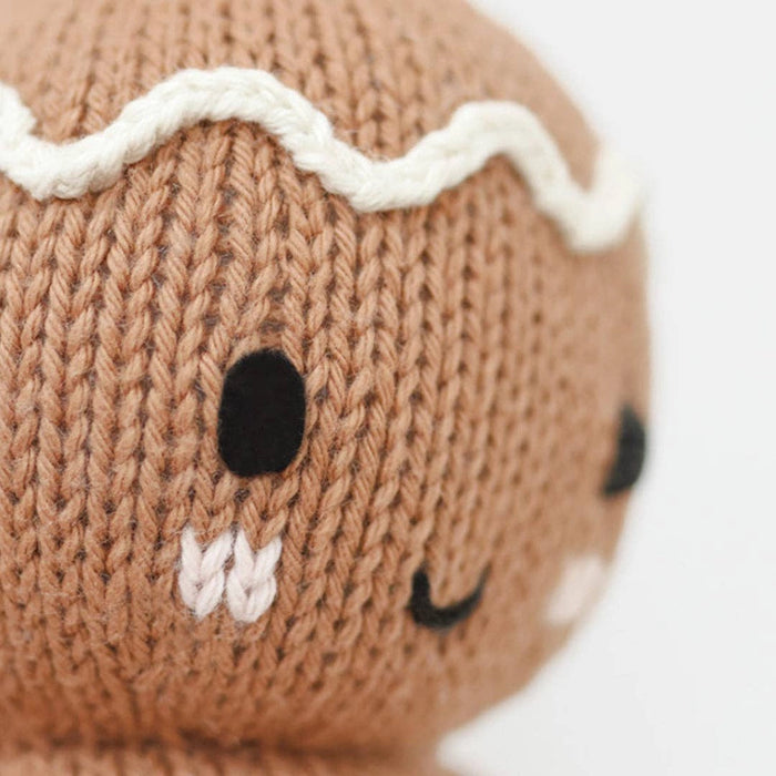 Knitted Cuddle + Kind baby gingerbread toy with a white background