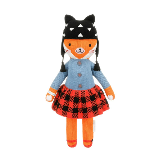 Full front view of Cuddle + Kind Sadie the Fox wearing a blue sweater, plaid skirt, and black knit hat
