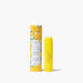 A tube of lip balm featuring a vibrant yellow and green design, showcasing its colorful packaging.