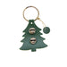 Green tree-shaped keychain with two metallic charms on a white background