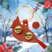 Red cardinal-shaped keychain with gold details on a festive background