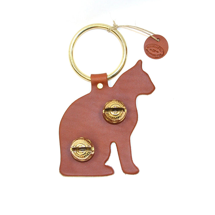 Brown leather cat-shaped keychain with gold accents on a white background
