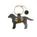 Black dog-shaped keychain with gold accents on a white background