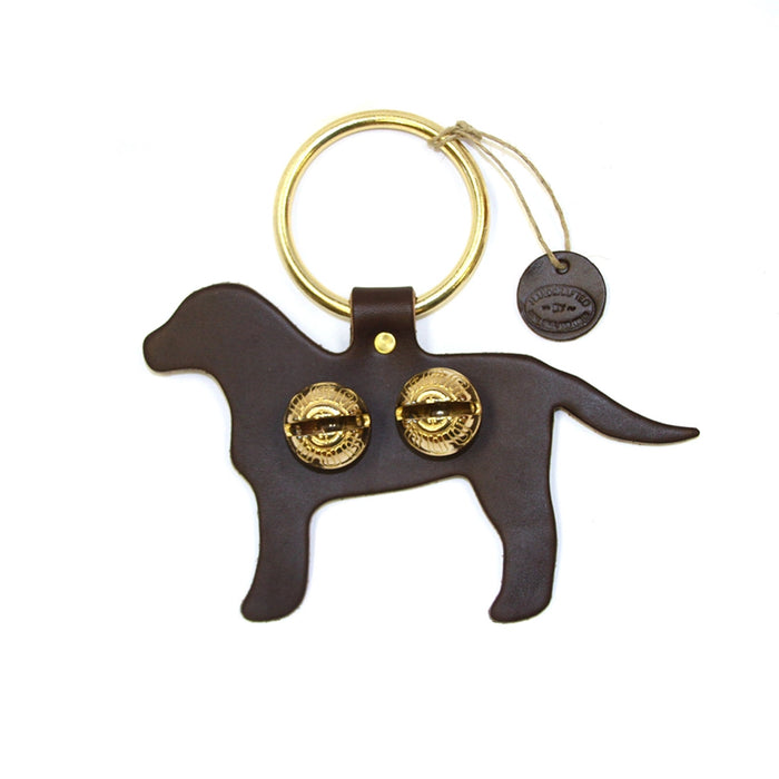 Dog-shaped keychain with gold details on a white background