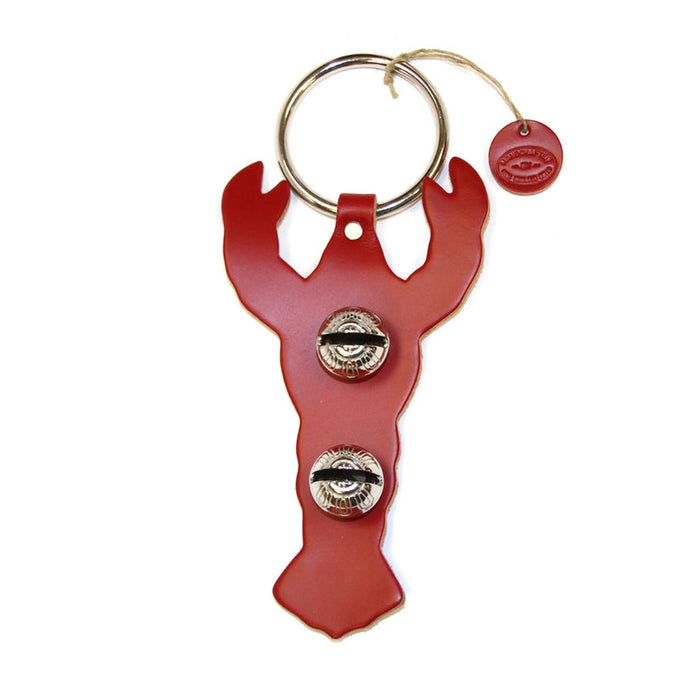 Red lobster-shaped bottle opener with two bottle caps on a white background