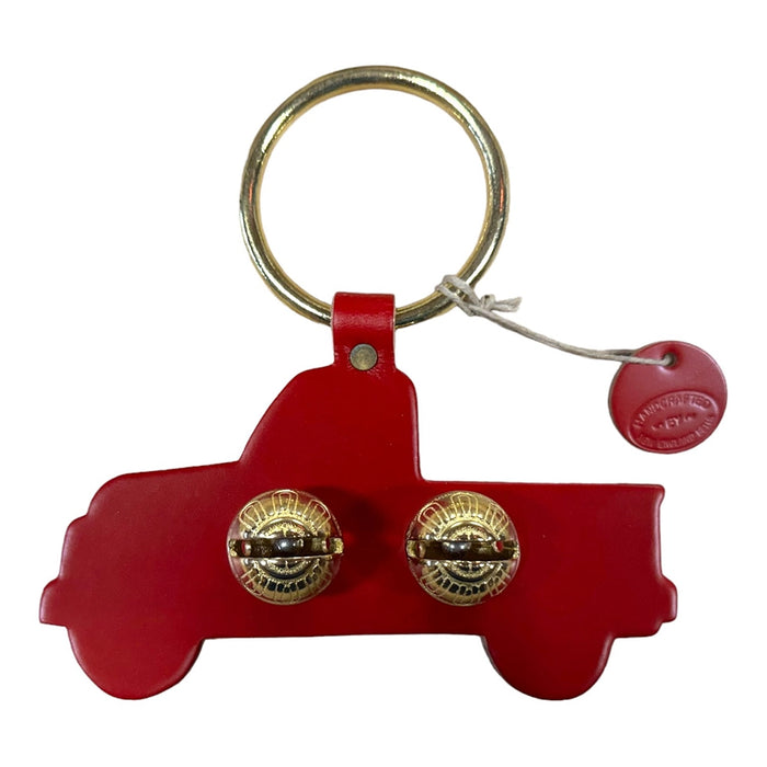 Red keychain shaped like a vintage car with gold details on a white background