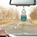 Desert Flower Car air freshener hanging from rearview mirror. 
