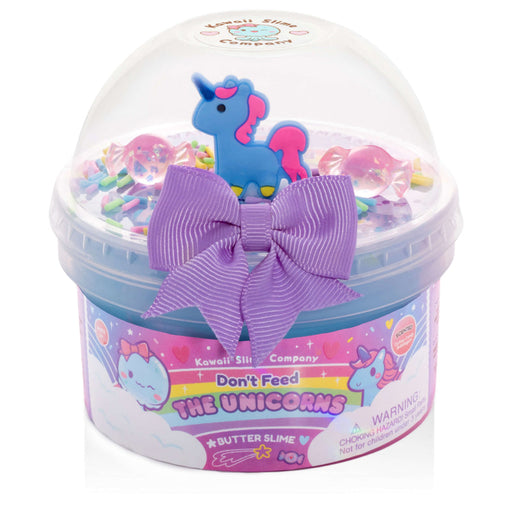 Butter slime with unicorn design and purple bow in a clear container, featuring Kawaii Slime Company branding.