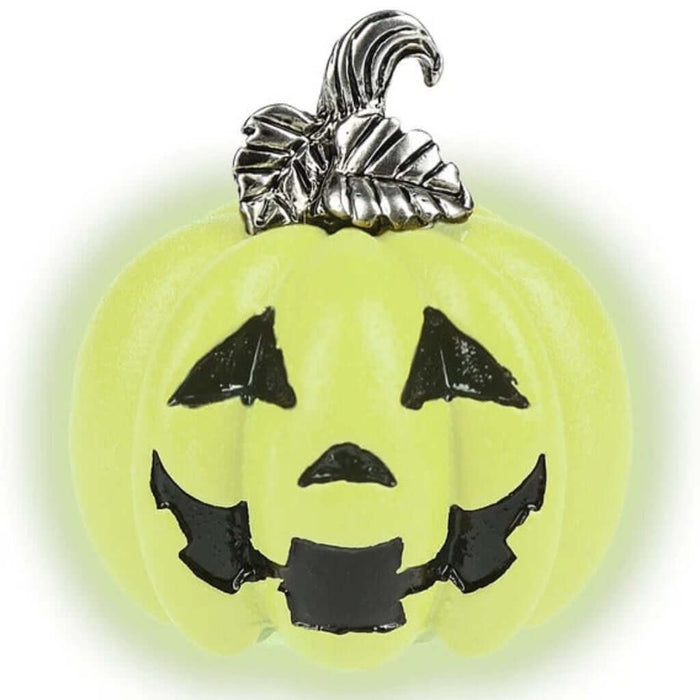 Glow in the dark pumpkin with smiling face  and a silver stem on a white background