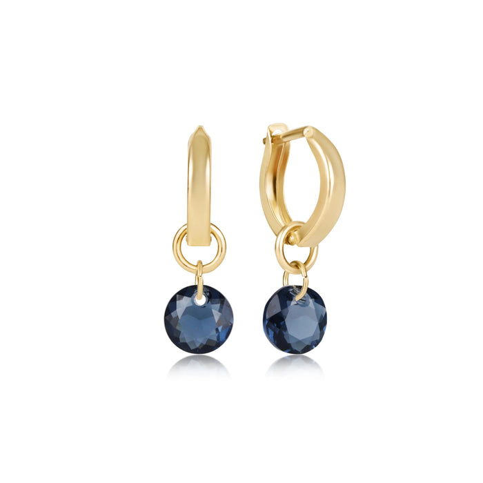 "Polished gold-tone hoop earrings.&nbsp;Sparkling faceted red crystal drop charms"