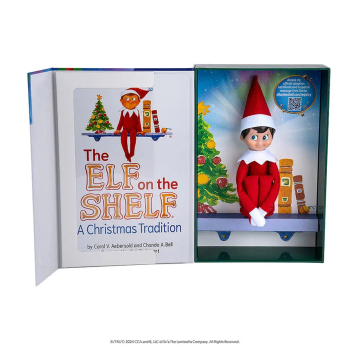 Open book titled 'The Elf on the Shelf: A Christmas Tradition' with an elf doll illustration on a white background.