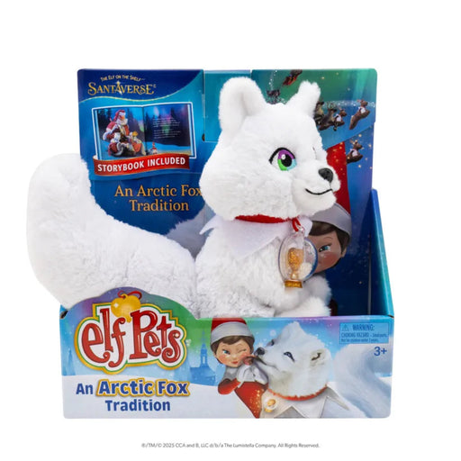White plush arctic fox toy with packaging featuring 'Elf Pets' branding and Sant'Verse logo.