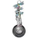 Decorative spoon with dragonfly designs and floral elements on a white background
