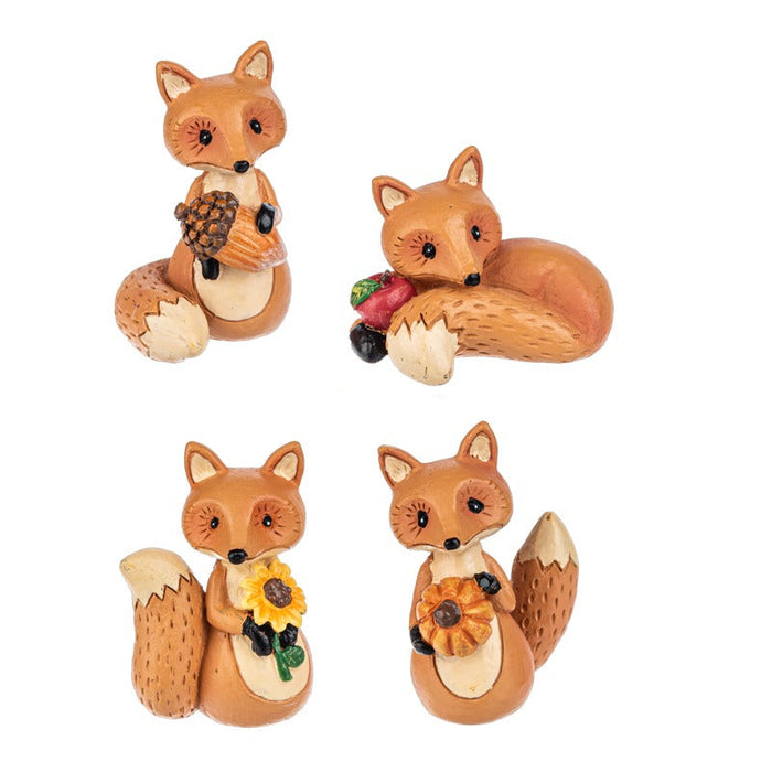 Set of four fox figurines with various accessories on a white background. Assorted not choice, one at random 