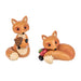 Two fox figurines, one holding acorns and the other with a apple , on a white background. Assorted not choice, one at random 