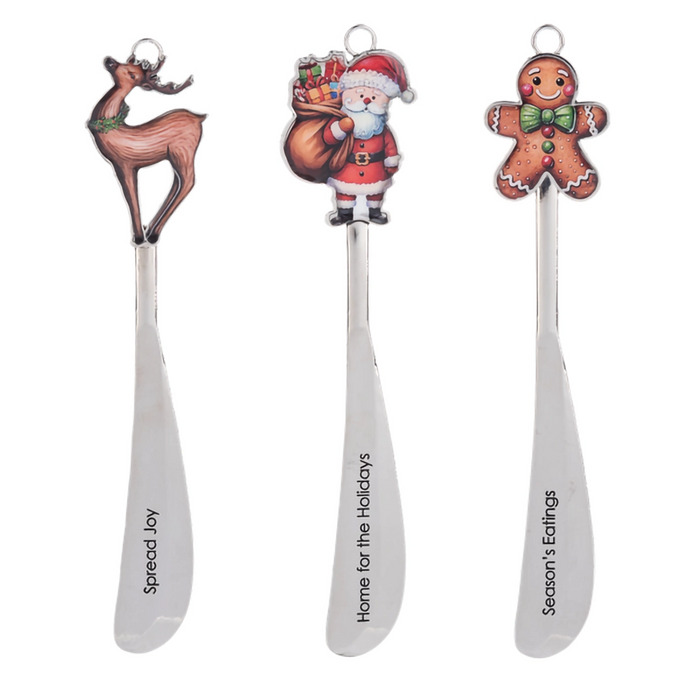Three Christmas-themed spoons with decorative ends on a white background