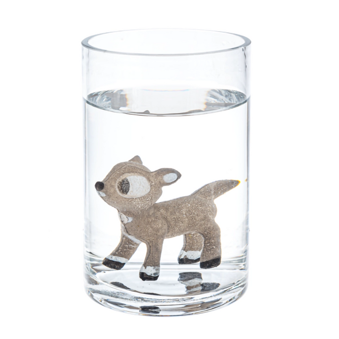 Clear glass with a deer design filled with water on a white background