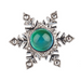 Silver snowflake-shaped brooch with a green gemstone on a white background