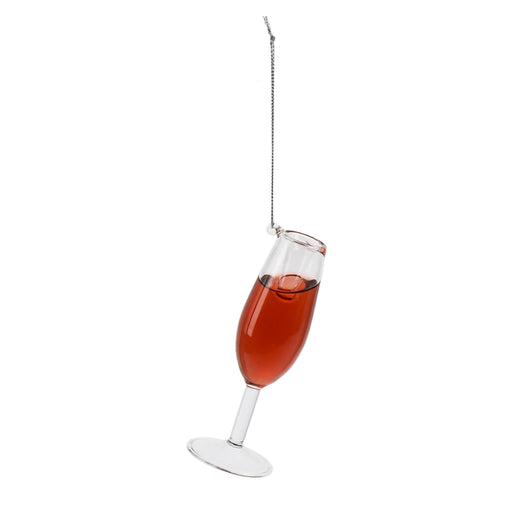 Champagne glass with red liquid on a white background