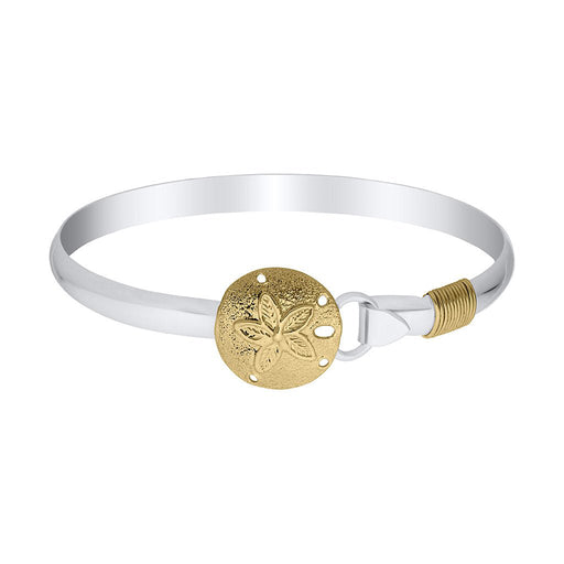 Silver bracelet with a gold sand dollar charm on a white background