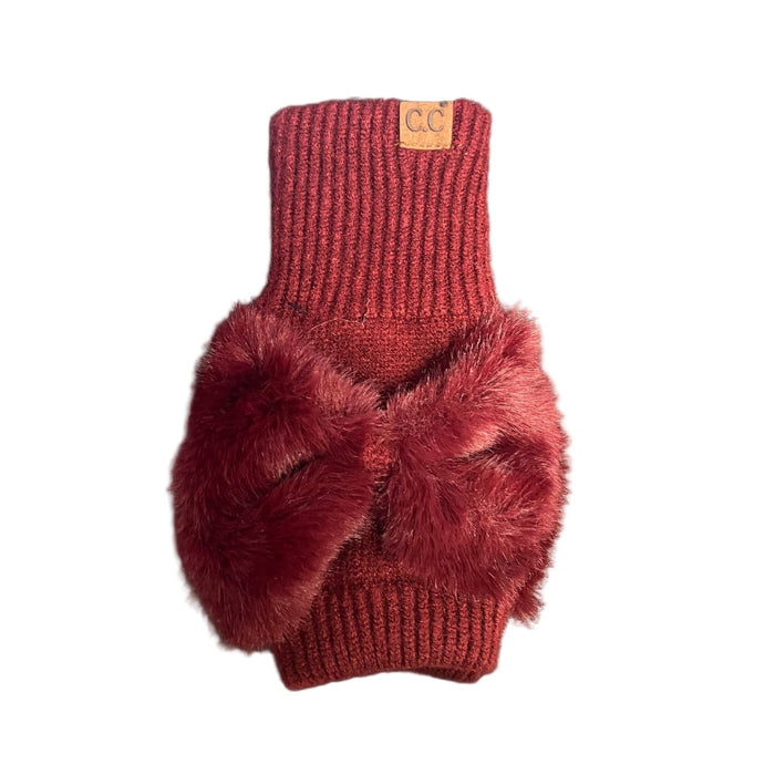 Red knitted glove with a fluff bow on a white background 