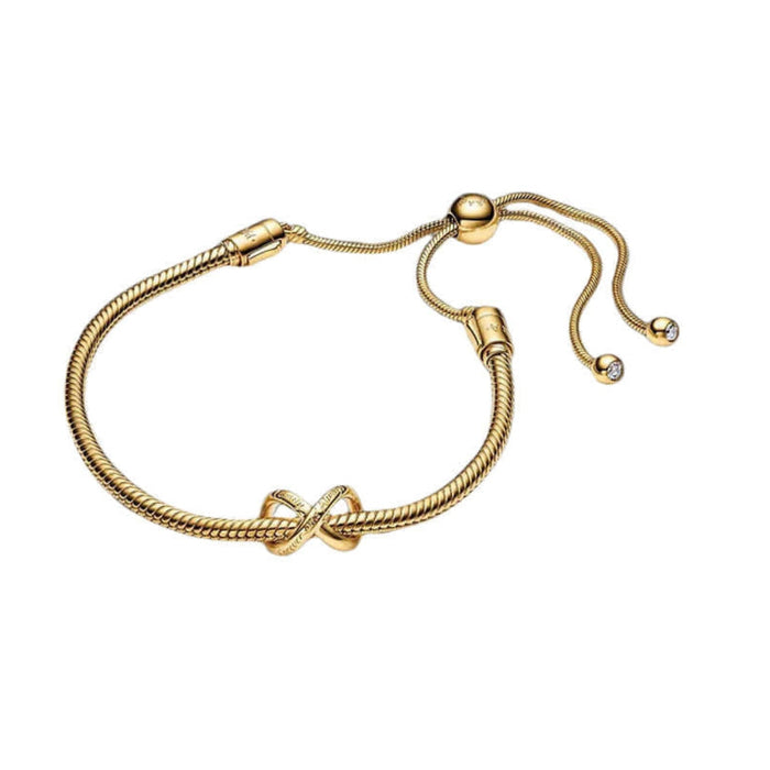 Gold bracelet with a knot design on a white background