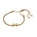 Gold bracelet with a knot design on a white background