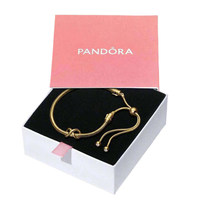 Gold bracelet in a Pandora box on a white background