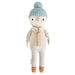 Cuddle + Kind Greyson the Penguin doll wearing a light blue knit hat with pom-pom, beige vest, and brown knit shoes.